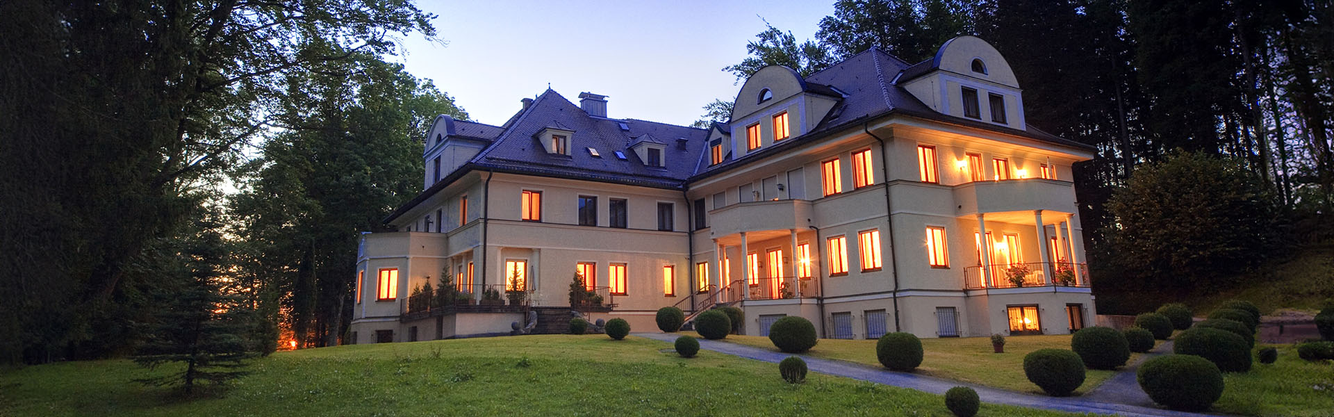 Außenansicht der Villa Toscana in Füssen mit Garten am Abend